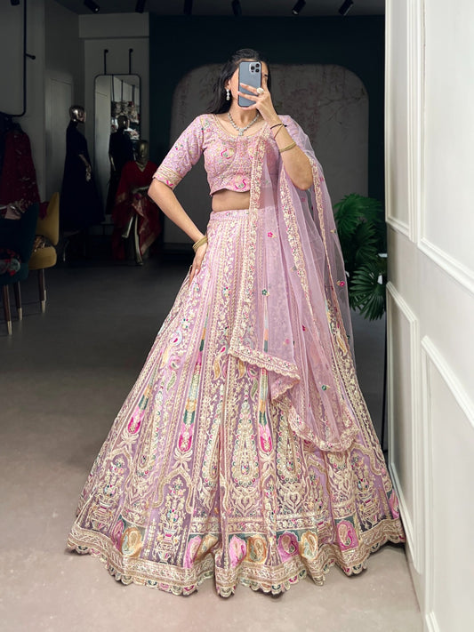 This pastel lehenga choli is a masterpiece of intricate embroidery and timeless elegance, crafted to make every celebration unforgettable