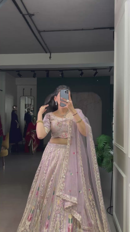 This pastel lehenga choli is a masterpiece of intricate embroidery and timeless elegance, crafted to make every celebration unforgettable